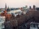 Aerial view of Brooklyn's cityscape featuring church spires and urban architecture at dusk.
