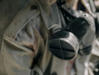 Detailed image of a respirator and protective suit, signifying safety in hazardous environments.