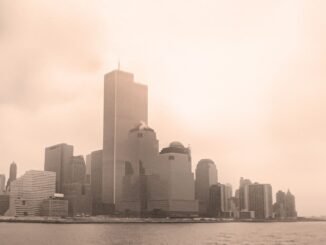 Sepia-toned view of New York City skyline with the Twin Towers on a foggy day.