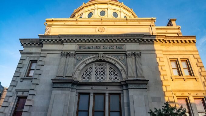 Detailed view of the historic Williamsburgh Savings Bank in Brooklyn, New York, captured at sunset.