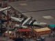 A detailed miniature scene of airplanes and people at a crowded airport display.