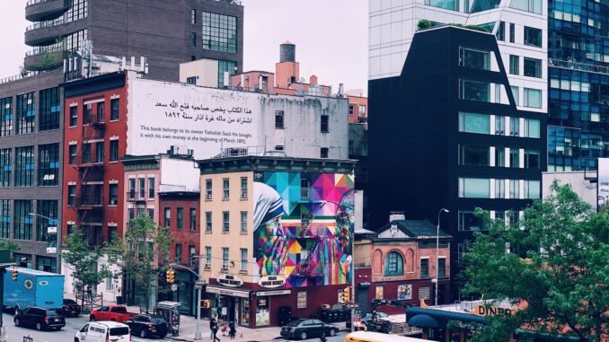 Colorful cityscape of New York with urban murals, modern architecture, and bustling street life.