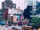 Colorful cityscape of New York with urban murals, modern architecture, and bustling street life.