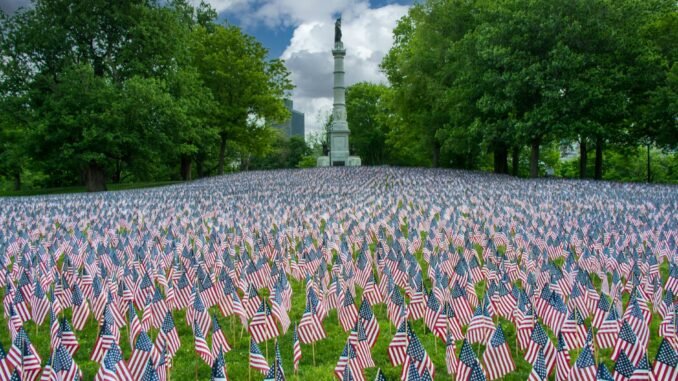 Thousands of American flags in Boston park honoring Memorial Day, symbolizing patriotism and remembrance.