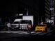 Cyclist navigates busy street in New York City traffic, surrounded by vehicles and buildings.