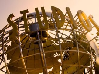 Iconic Universal Studios globe sculpture at sunset, symbolizing Hollywood magic.