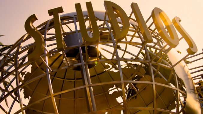 Iconic Universal Studios globe sculpture at sunset, symbolizing Hollywood magic.