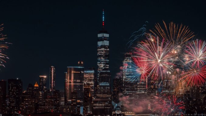 Colorful fireworks illuminating the New York City skyline at night, capturing a vibrant celebration.