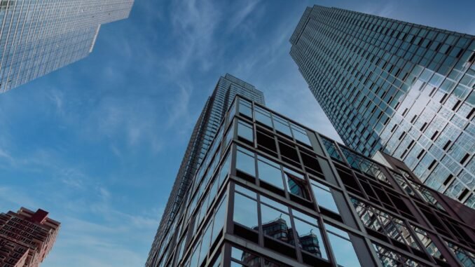 A captivating view of New York City's modern skyscrapers against a clear blue sky, showcasing urban architecture.
