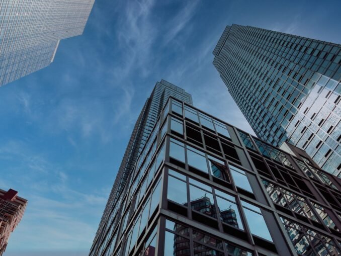 A captivating view of New York City's modern skyscrapers against a clear blue sky, showcasing urban architecture.